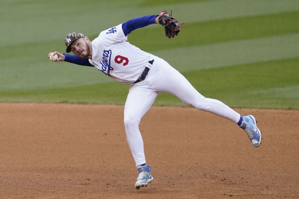 Dodgers shortstop Gavin Lux throws to first during a win over the Miami Marlins on Sunday.