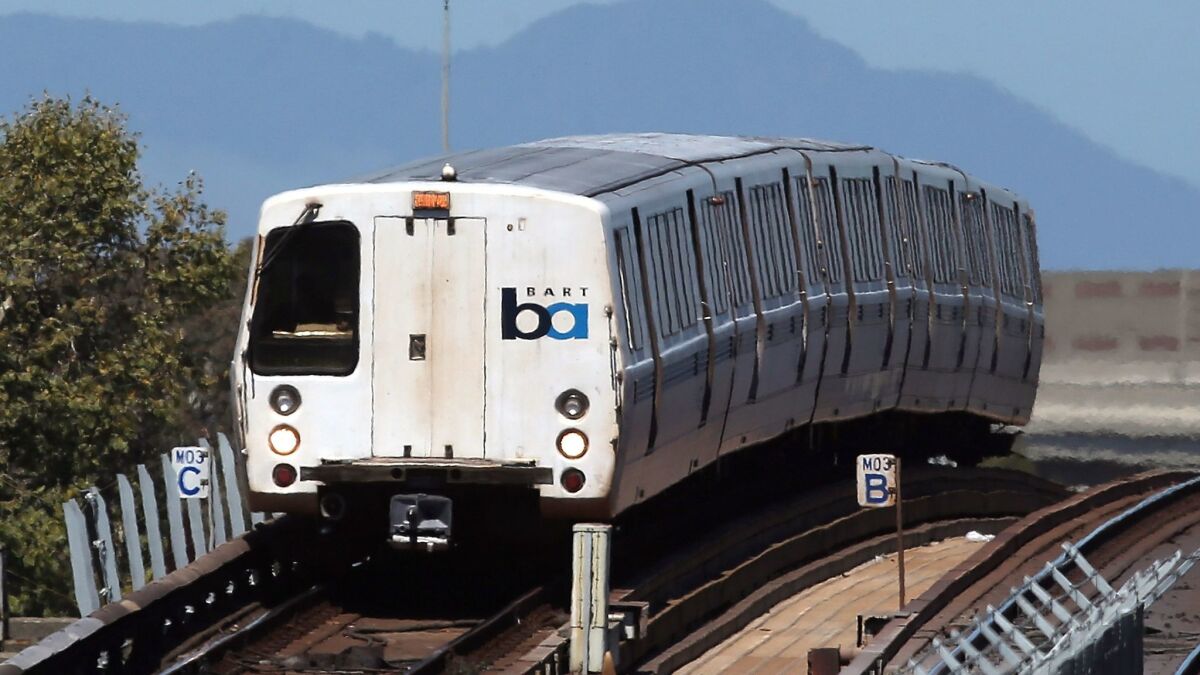 A BART train travels toward downtown Oakland.