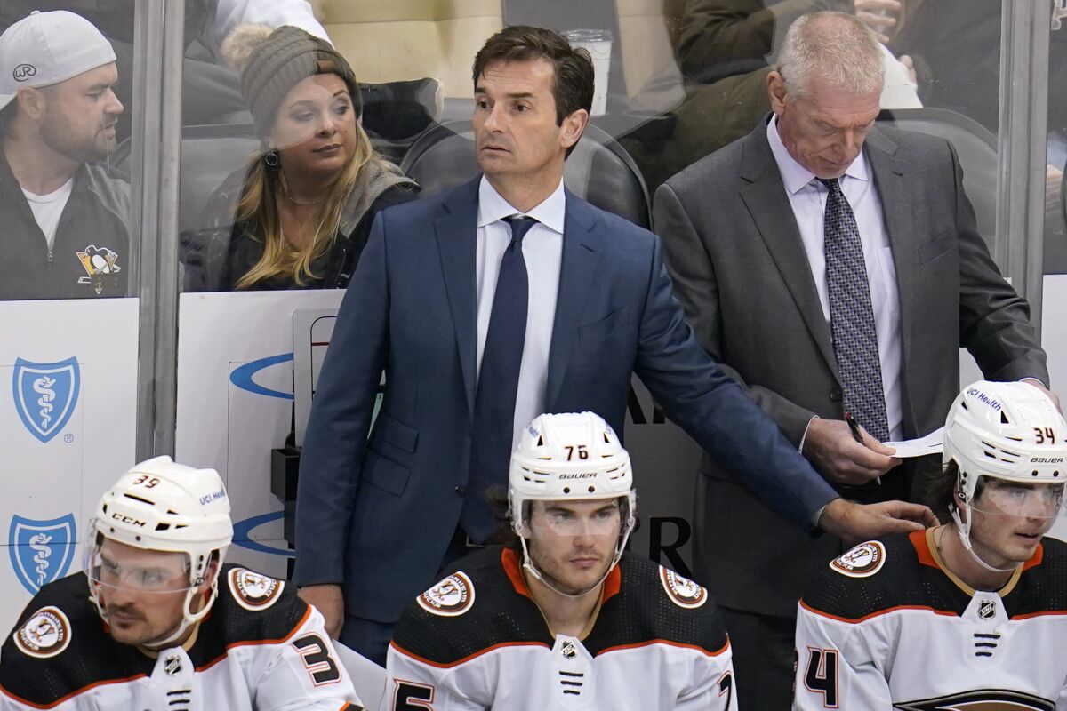 Ducks coach Dallas Eakins, center rear, stands behind his bench during a game against the Pittsburgh Penguins in December.