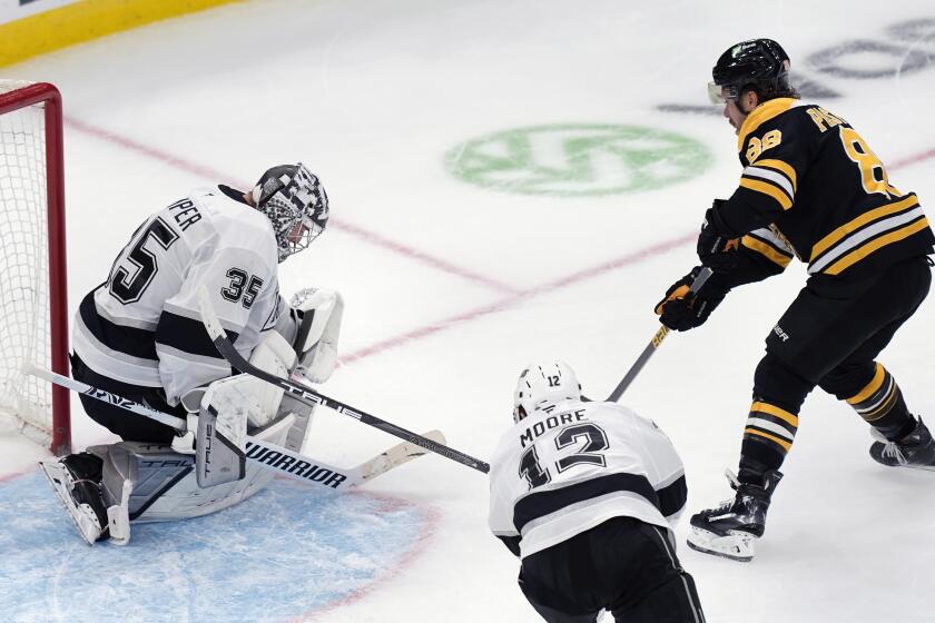 Boston Bruins' David Pastrnak (88) scores on Los Angeles Kings' Darcy Kuemper (35) during overtime in an NHL hockey game, Saturday, Oct. 12, 2024, in Boston. (AP Photo/Michael Dwyer)