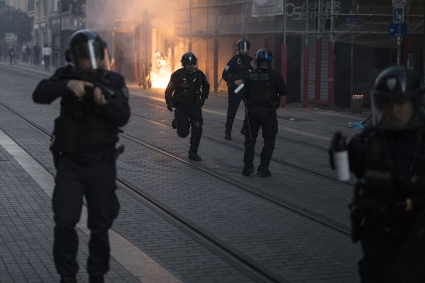 Police advance on protesters during a march against police brutality and racism in Marseille, France, Saturday, June 13, 2020, organized by supporters of Adama Traore, who died in police custody in 2016 in circumstances that remain unclear despite four years of back-and-forth autopsies. Several demonstrations went ahead Saturday inspired by the Black Lives Matter movement in the U.S. (AP Photo/Daniel Cole)