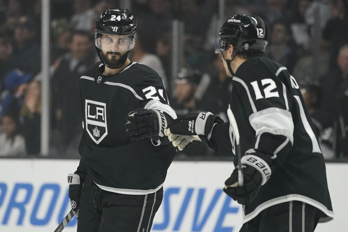 Kings center Phillip Danault celebrates with center Trevor Moore after scoring.