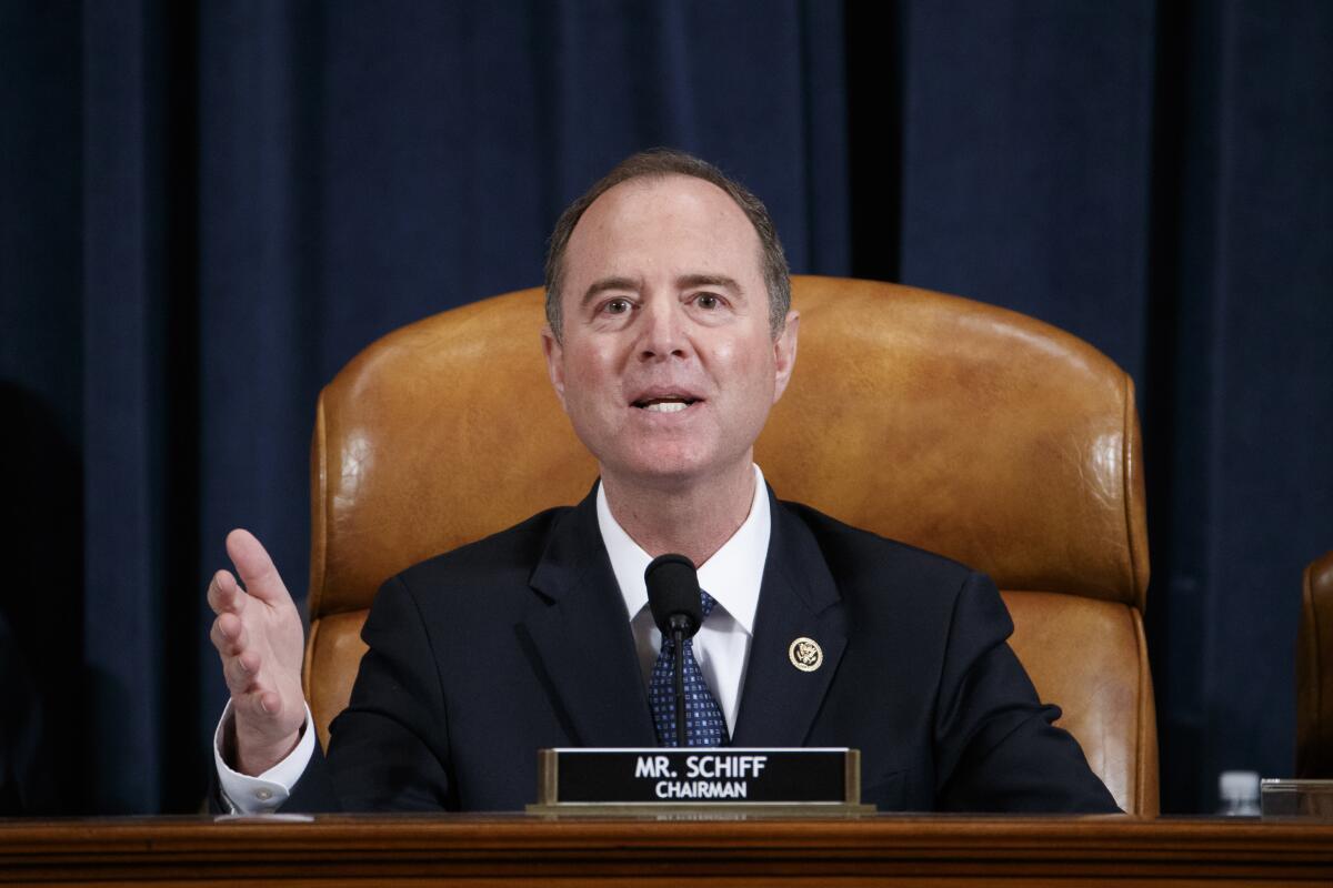 Adam Schiff  seated at dais with nameplate that reads Mr. Schiff, chairman 
