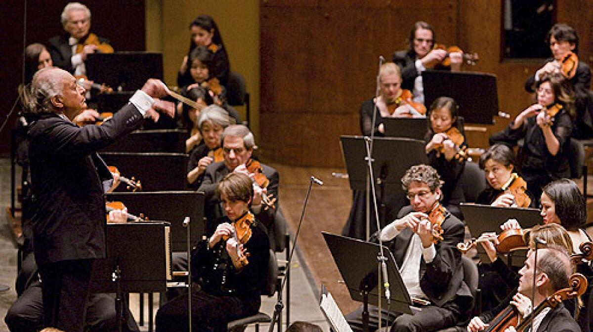 In this photo released by the New York Philharmonic, Lorin Maazel, left, conducts the orchestra at Avery Fisher Hall on Jan. 30, 2008.