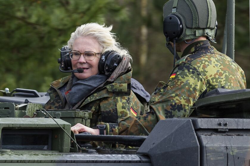 FILE - Christine Lambrecht, Minister of Defense, rides in a tank during her visit to the Tank Training Brigade 9 in Munster, Germany, Feb. 7, 2022. Defense Minister Christine Lambrecht resigns. She has asked Chancellor Olaf Scholz to dismiss her, said a statement from the minister on Monday. (Philipp Schulze/dpa via AP, File)