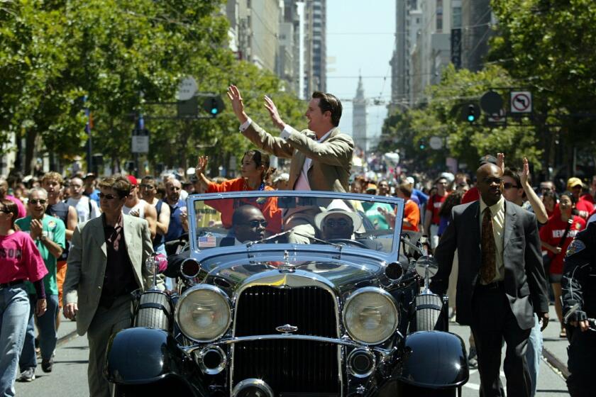 San Francisco Mayor Gavin Newsom, center, waves to the crowds at the 34th annual Gay Pride Parade down Market Street in San Francisco, Sunday, June 27, 2004. Newsom made a controversial decision to grant marriage licenses to same-sex couples in February of this year. (AP Photo/Dino Vournas) ORG XMIT: CADV104