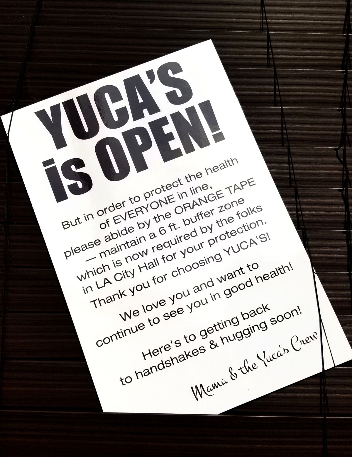 A sign says "Yuca's is Open!" 