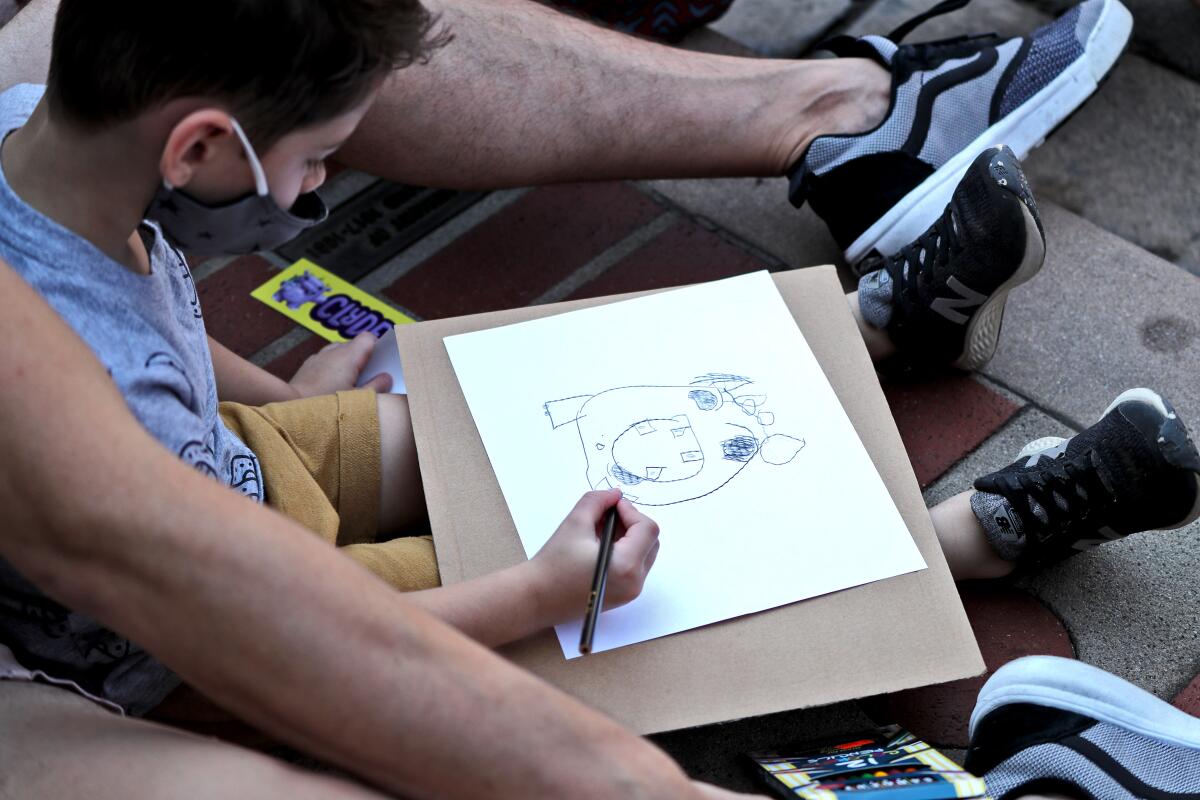 Dylan Vargas, 4, drawing a book character during event at Tiddlywinks Toys and Games store 