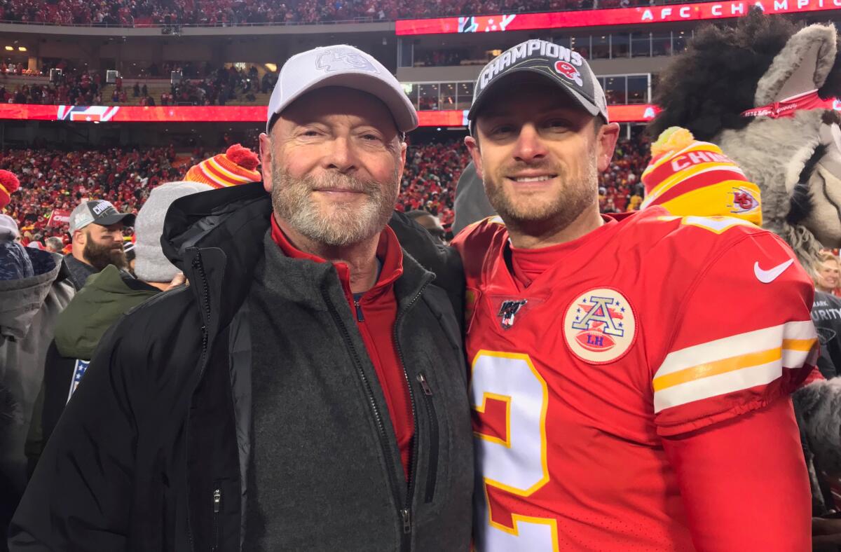 Craig Colquitt (left) and son Dustin enjoy a moment after the Chiefs' AFC championship victory.