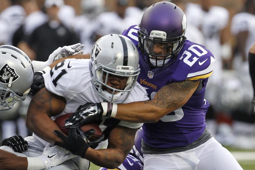 Oakland Raiders running back Maurice Jones-Drew is wrapped up by Minnesota Vikings safety Kurt Coleman during the first half of a preseason game on Friday at TCF Bank Stadium in Minneapolis. The Vikings defeated the Raiders, 10-6.