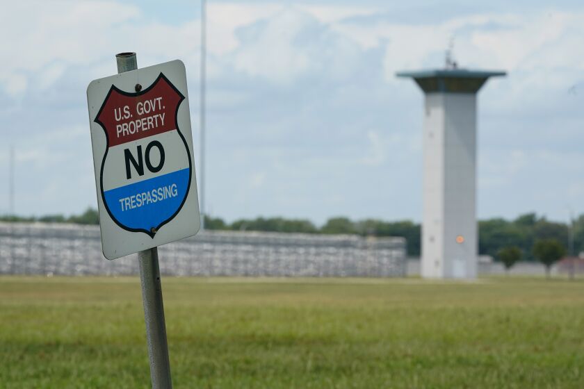 In this Aug. 28, 2020, file photo, a no trespassing sign is displayed outside the federal prison complex in Terre Haute, Ind. As Donald Trump’s presidency winds down, his administration is throttling up the pace of federal executions despite a surge of COVID-19 cases in prison, announcing plans for five executions just days before the Jan. 20 inauguration of death penalty foe Joe Biden. Attorney General William Barr defends the action in an interview with The Associated Press and says he will likely schedule additional executions before leaving the Cabinet. (AP Photo/Michael Conroy, File)