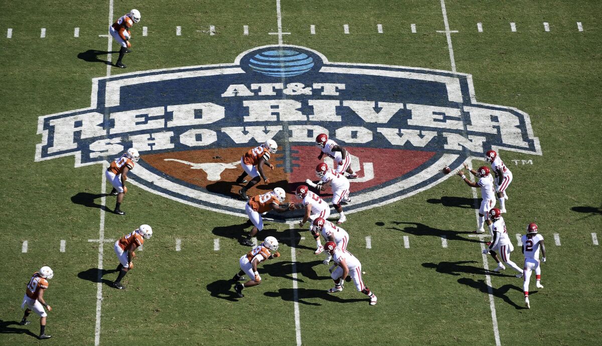 FILE - In this Oct. 12, 2019, file photo, Oklahoma, right, runs a play against Texas in the first half of an NCAA college football game at the Cotton Bowl in Dallas. The Big 12 will have nothing like the Red River rivalry on the second Saturday in October once Texas and Oklahoma make their move to the Southeastern Conference. (AP Photo/Jeffrey McWhorter, File)