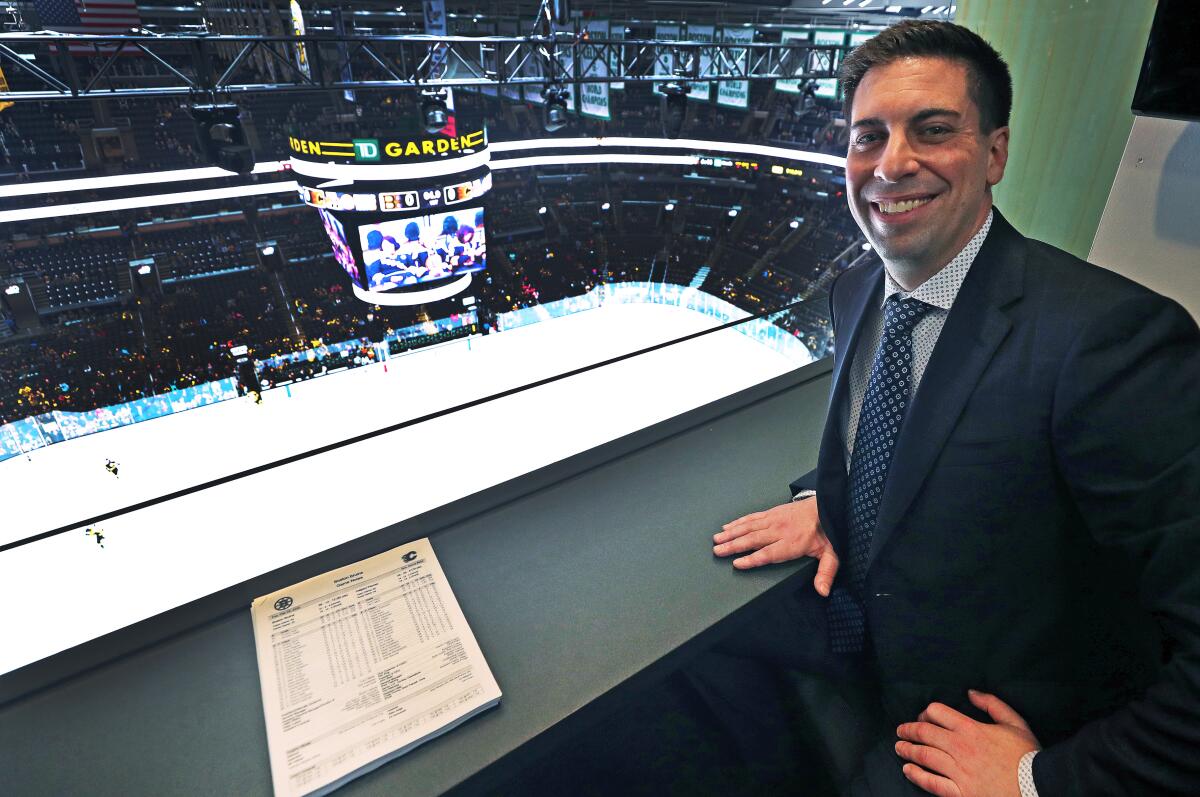 Chris Snow poses for a portrait in a press box above the ice