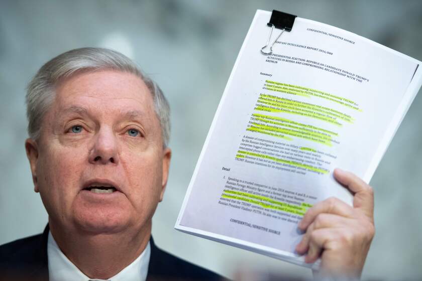 Chairman of the Senate Judiciary Committee Lindsey Graham, Republican of South Carolina, holds a copy of the Steele Dossier, as Justice Department Inspector General Michael Horowitz testifies about the Inspector General's report on alleged abuses of the Foreign Intelligence Surveillance Act (FISA) during a Senate Judiciary Committee hearing on Capitol Hill in Washington, DC, December 11, 2019. (Photo by SAUL LOEB / AFP) (Photo by SAUL LOEB/AFP via Getty Images) ** OUTS - ELSENT, FPG, CM - OUTS * NM, PH, VA if sourced by CT, LA or MoD **