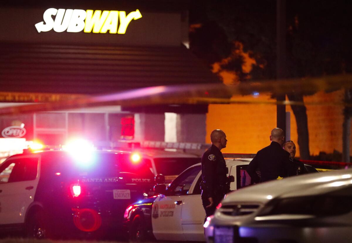 Police outside a Subway shop in Santa Ana, where one man was killed.