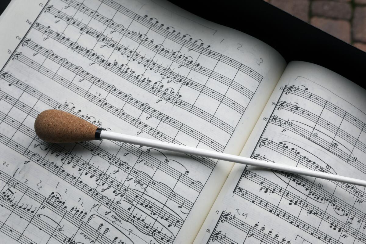 A book of sheet music and a baton.