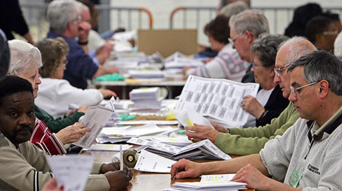 Election workers prepare absentee ballots for tabulation at the Cuyahoga County Board of Elections warehouse in Cleveland Friday, Feb. 29, 2008.