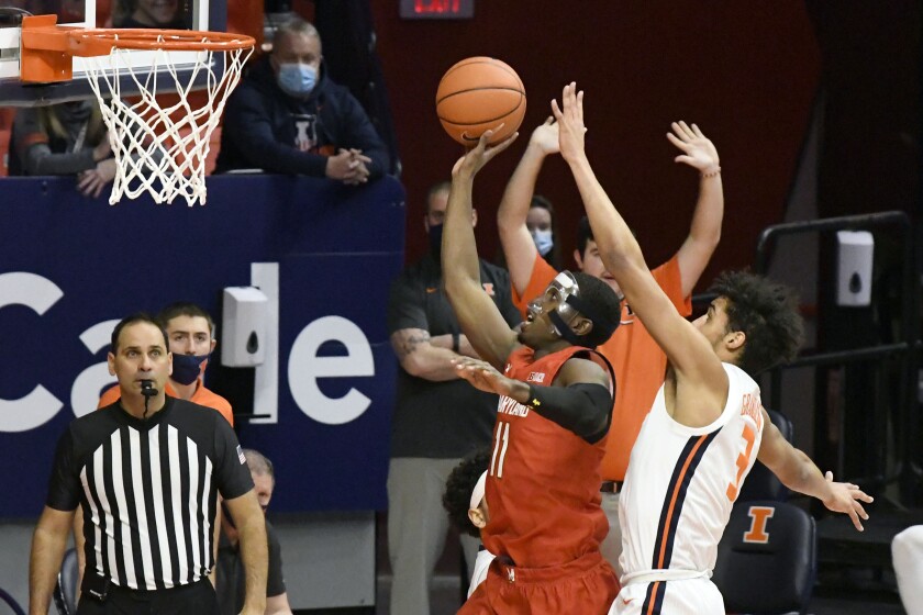 Maryland guard Darryl Morsell (11) shoots as Illinois guard Jacob Grandison (3) defends in the first half of an NCAA college basketball game, Sunday, Jan. 10, 2021, in Champaign, Ill. (AP Photo/Holly Hart)