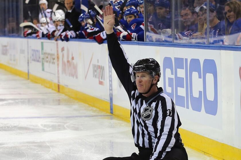 Linesman Jean Morin #97 makes a first period icing call during the game between the New York Rangers and the Washington Capitals in Game Three of the Eastern Conference Quarterfinals during the 2013 NHL Stanley Cup Playoffs at Madison Square Garden on May 6, 2013.