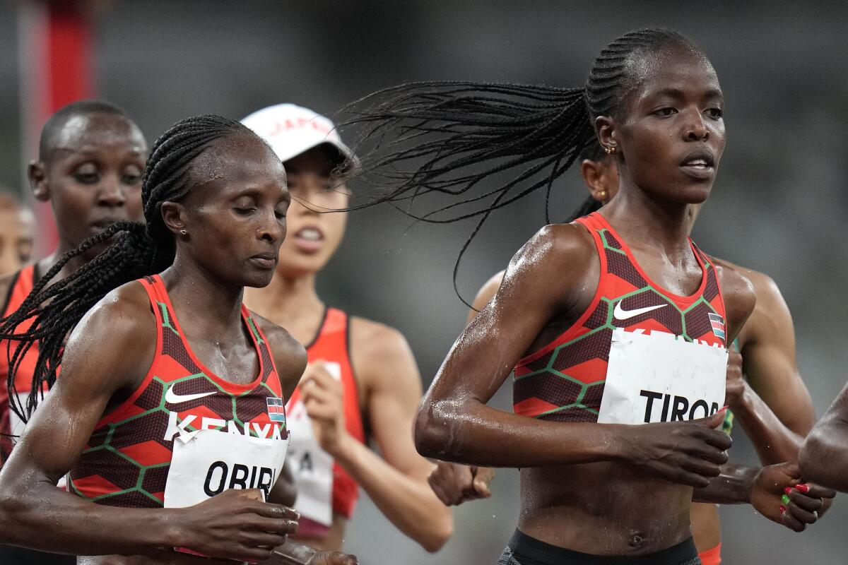 ARCHIVO - Agnes Tirop (derecha) compite en la final de los 5.000 metros femenil 