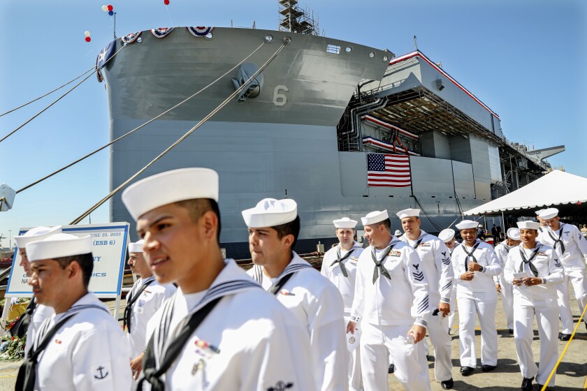 Navy sailors attached to the USS John Canley walk out after the ship's christening ceremony at NASSCO.