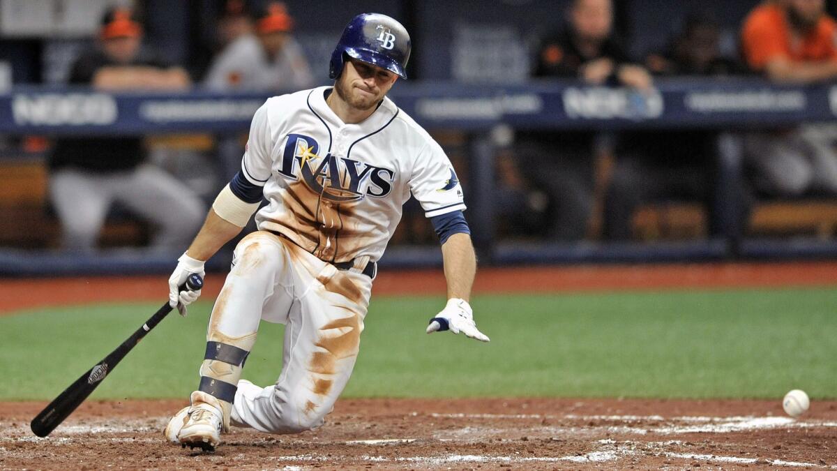 Rays second baseman Brandon Lowe falls to the dirt after hitting a foul tip off his right leg during a game July 2, 2019.