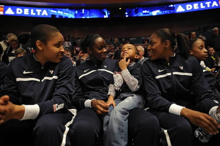 Devin Dixon, 7, sits on Samarie Walker's lap as Maya Moore, Taffany Hayes and Lorin Dixon await the start of their game against Ohio State at Madison Square Garden Sunday afternoon.