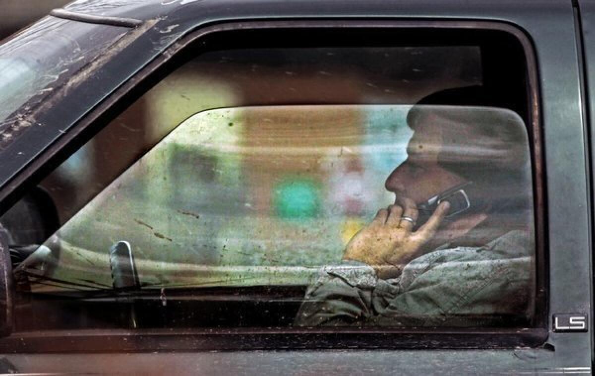 A driver talks on the phone on Tuesday in Montpelier, Vt. The National Highway Traffic Safety Administration says that there are 660,000 distracted drivers on the road at any given moment of the day.