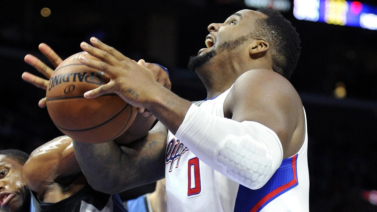 Clippers forward Glen Davis, right, is fouled by Minnesota Timberwolves forward Thaddeus Young while attempting a shot during the Clippers' 127-101 victory at Staples Center on Monday.