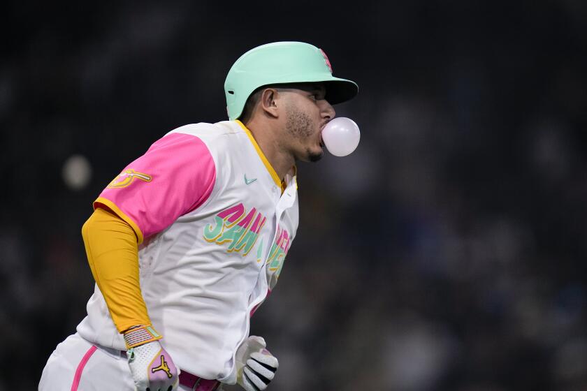 San Diego Padres' Manny Machado blows a bubble as he rounds the bases after hitting a home run during the sixth inning of a baseball game against the St. Louis Cardinals, Friday, Sept. 22, 2023, in San Diego. (AP Photo/Gregory Bull)
