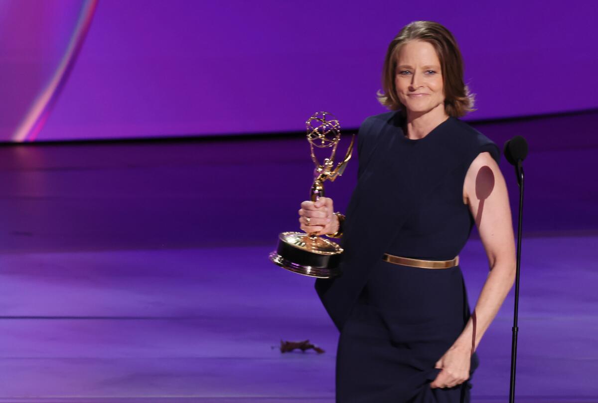 Jodie Fosterholds her Emmy award on stage.