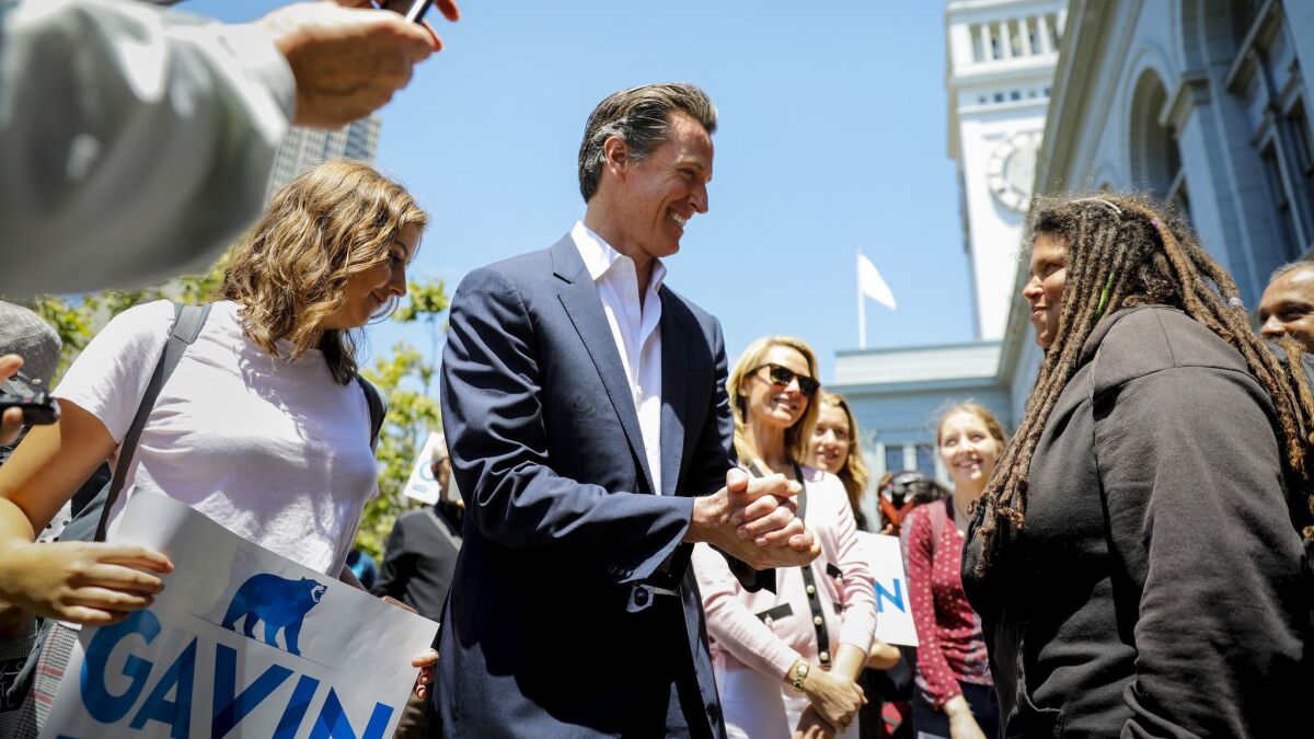 Lt. Gov. Gavin Newsom, center, talks to supporters in San Francisco on June 6, the morning after advancing to the general election in his campaign for California governor.