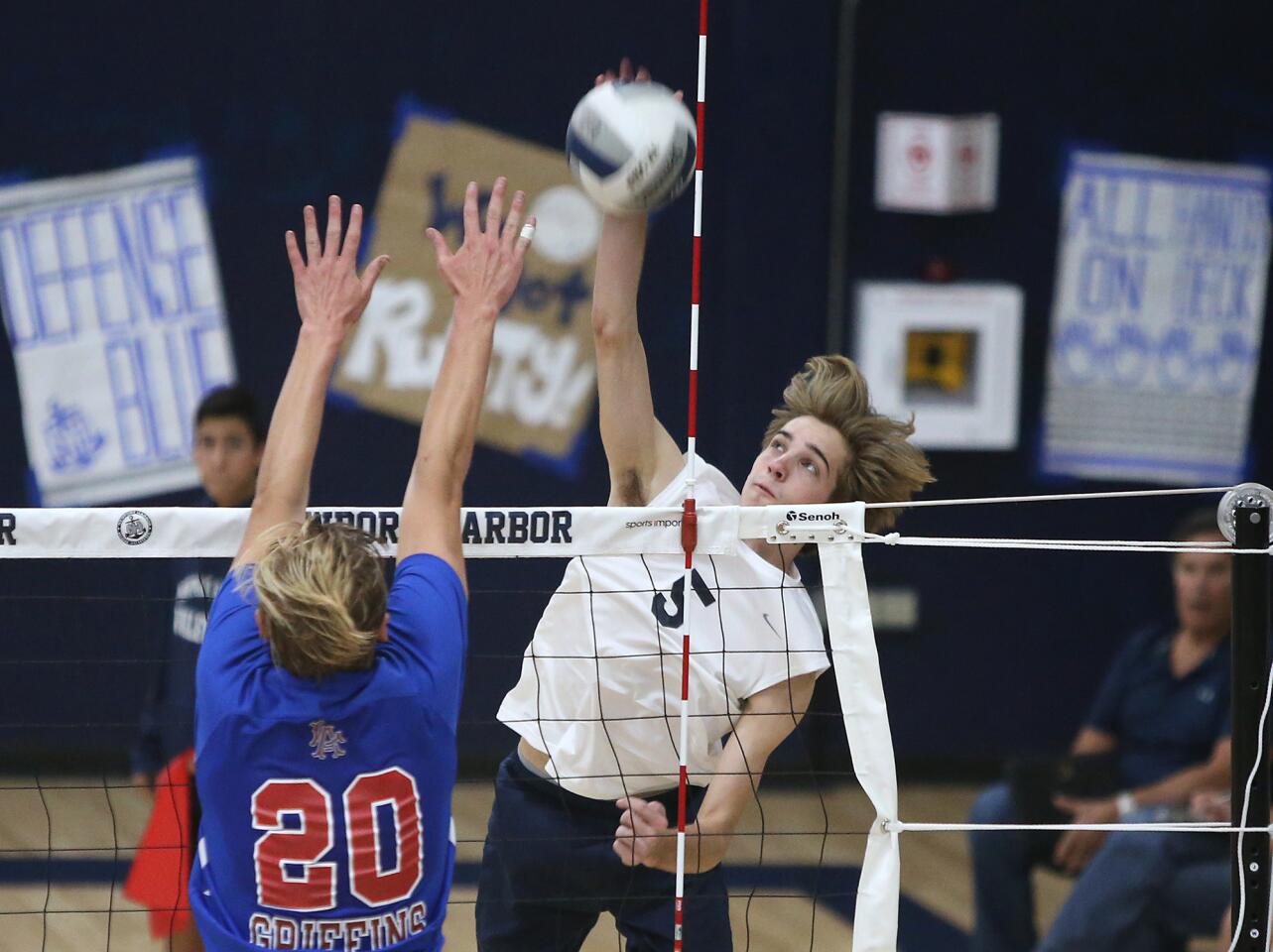 Newport Harbor High's Cole Pender hits a kill from the outside during boys' Sunset League volleyball against Los Alamitos on Friday.