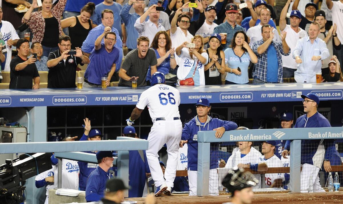 Dodgers center fielder Yasiel Puig is congratulated by Manager Don Mattingly after leading off the bottom of the sixth inning with a home run against the Giants on Wednesday night at Dodger Stadium.