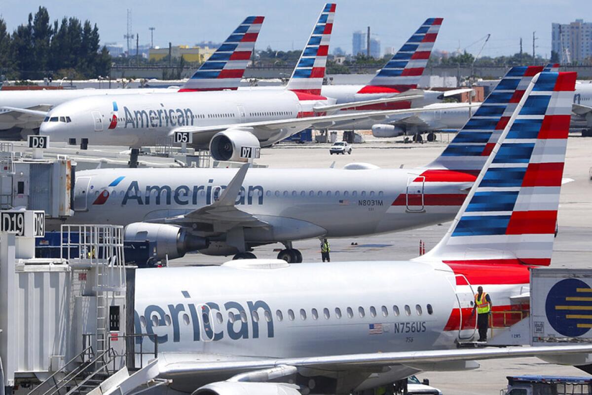 American Airlines jets parked at an airport terminal