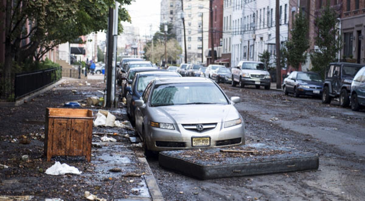 Mud and debris liiter a street in Hoboken, N.J., which was hit hard by the storm.