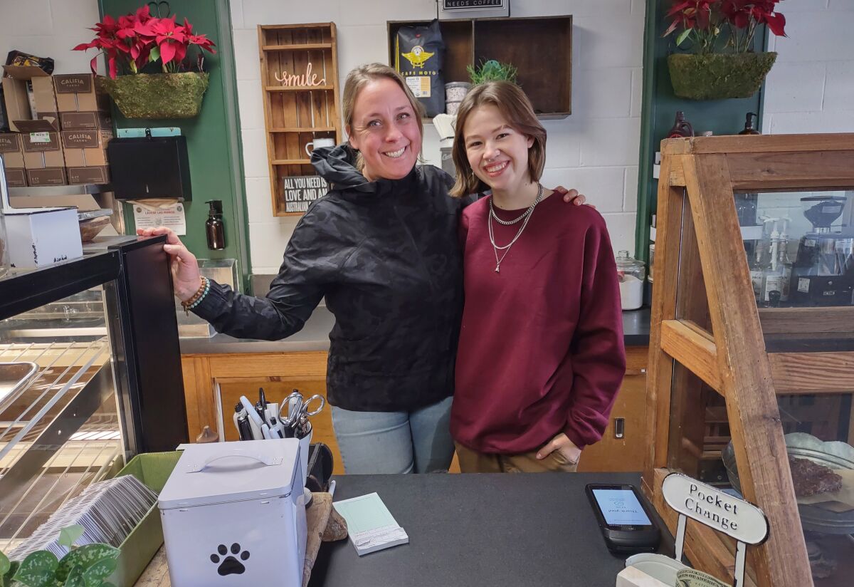 Cattle Dog Café owner Chelsea Schoeni, left, and staff member Alexavia Zetterberg wait on coffee customers at 632 Main St.