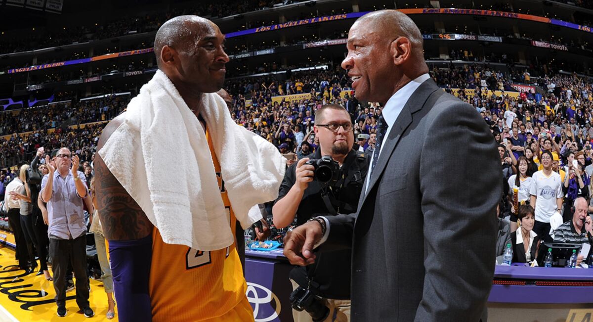 Lakers legend Kobe Bryant and Clippers coach Doc Rivers chat after a game in 2016.