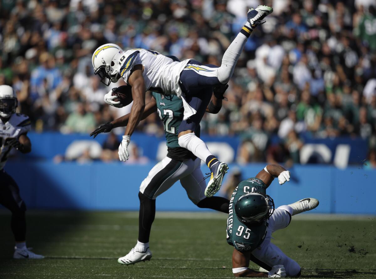 Los Angeles Chargers wide receiver Tyrell Williams (16), above, leaps over Philadelphia Eagles outside linebacker Mychal Kendricks (95) below, during the second half of an NFL football game Sunday, Oct. 1, 2017, in Carson, Calif.