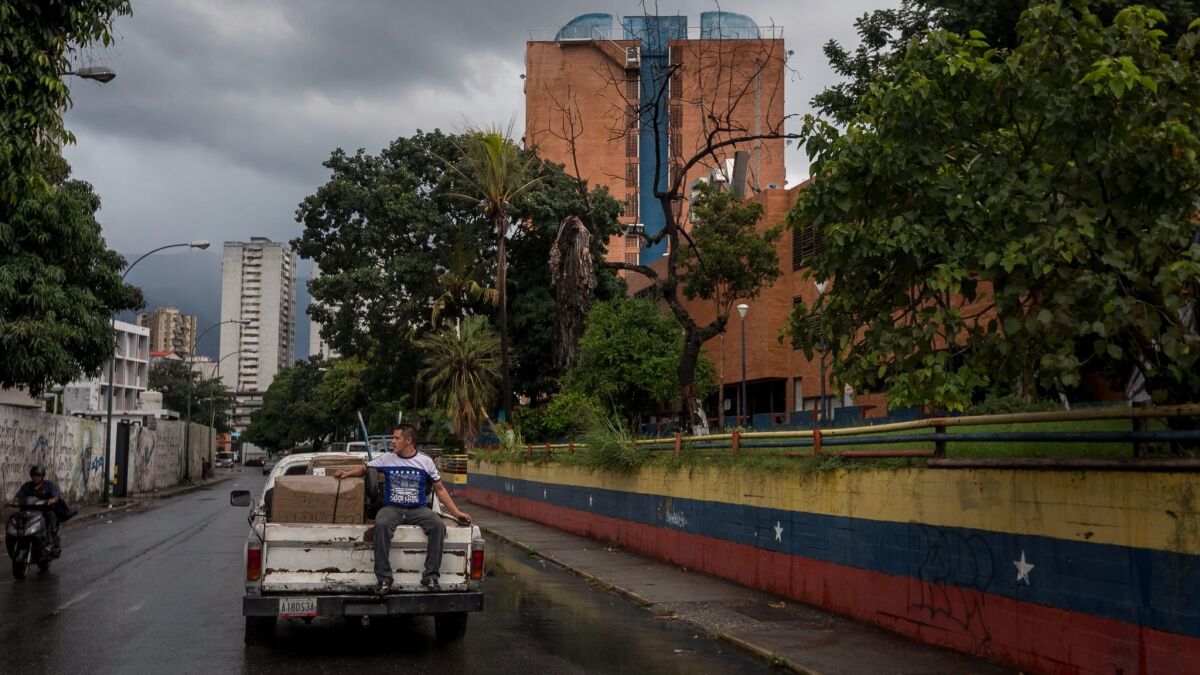 In Caracas, Jose Caicedo takes food and clothing sent by sister Tere in Los Angeles to the Providence San Antonio Asylum, a retirement home for low-income men.