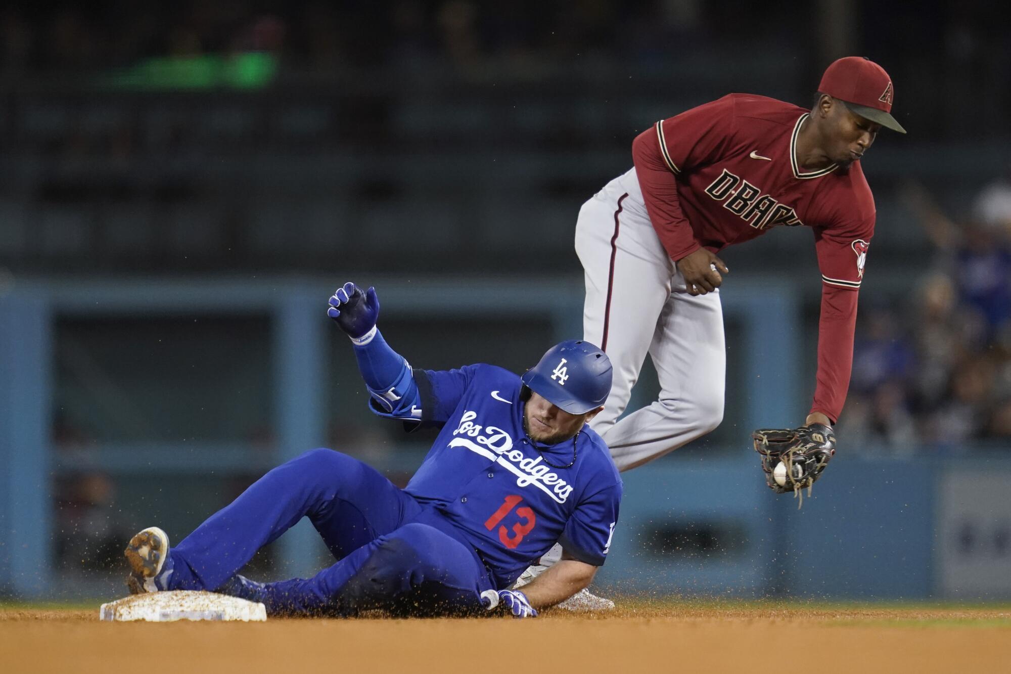 Max Muncy reaches second on a double ahead of a throw to Geraldo Perdomo.