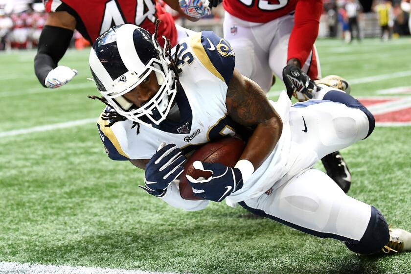 ATLANTA, GEORGIA OCTOBER 20, 2019-Rams running back Todd Gurley catches a touchdown pass in front of Falcon defenders Vic Beasley Jr. (44) and Jamal Carter in the 2nd quarter at Mercedez Benz Stadium in Atlanta Sunday. (Wally Skalij/Los Angeles Times)