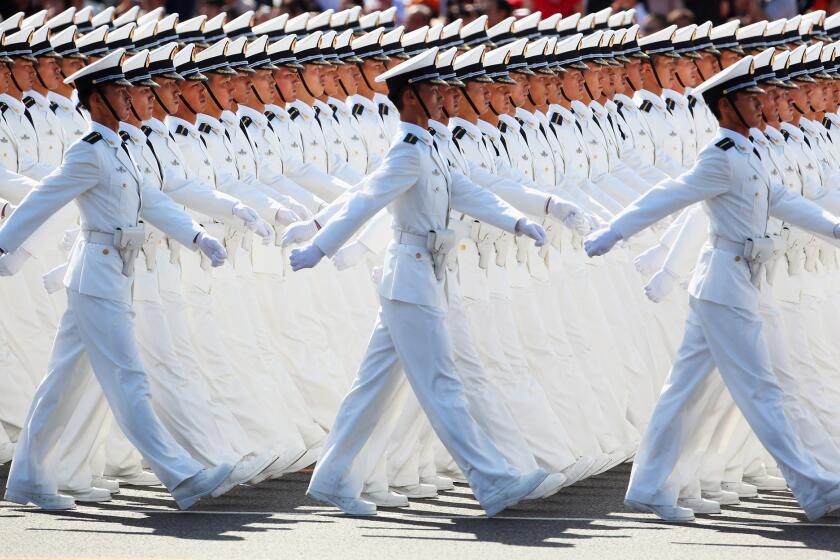 In a 2009 file photo, Chinese People's Liberation Army sailors march pass Tiananmen Square during the celebration of the 60th anniversary of the founding of the People's Republic of China.