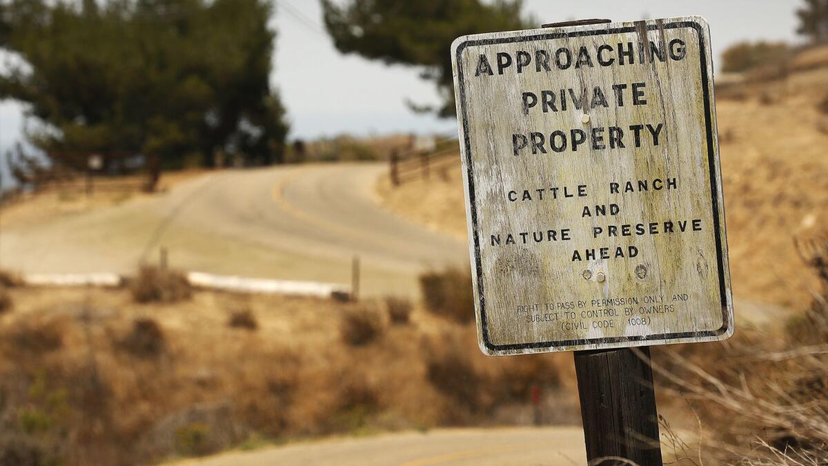A sign warns of possible trespassing on Hollister Ranch Road.