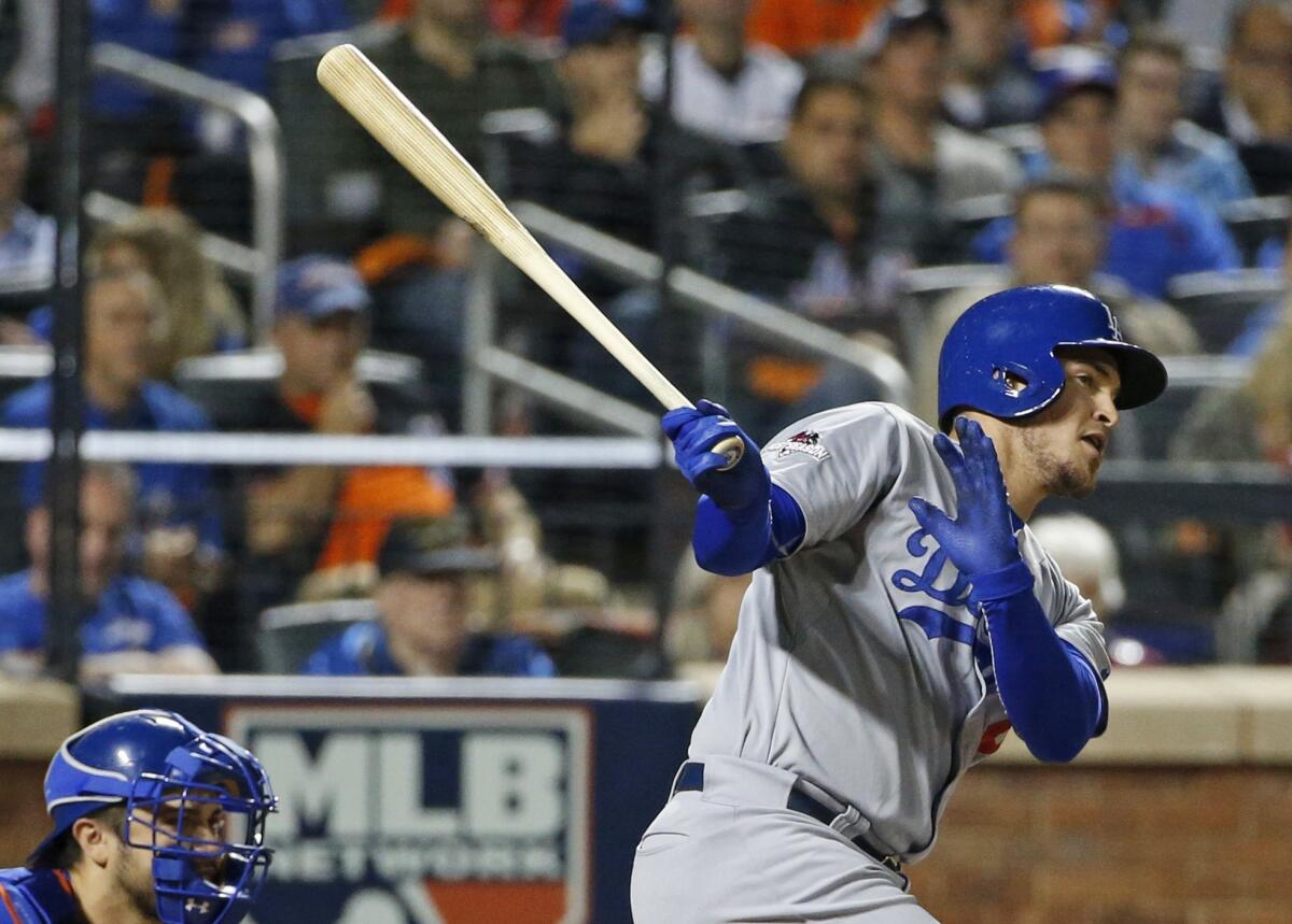 Yasmani Grandal hits a three-run double Monday during Game 3 of the Dodgers' National League division series against the New York Mets.