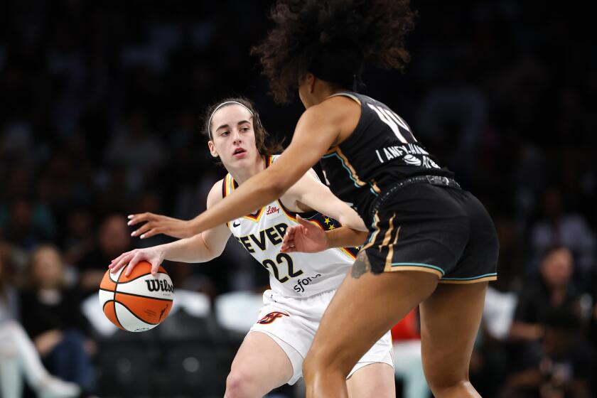 Indiana Fever guard Caitlin Clark (22) dribbles the ball against New York Liberty forward Betnijah Laney-Hamilton (44) during the first half of a WNBA basketball game, Saturday, May 18, 2024, in New York. (AP Photo/Noah K. Murray)