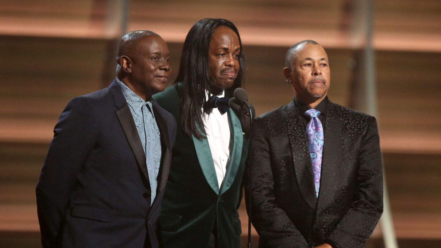 Philip Bailey, from left, Verdine White and Ralph Johnson of Earth Wind & Fire present the award for album of the year.