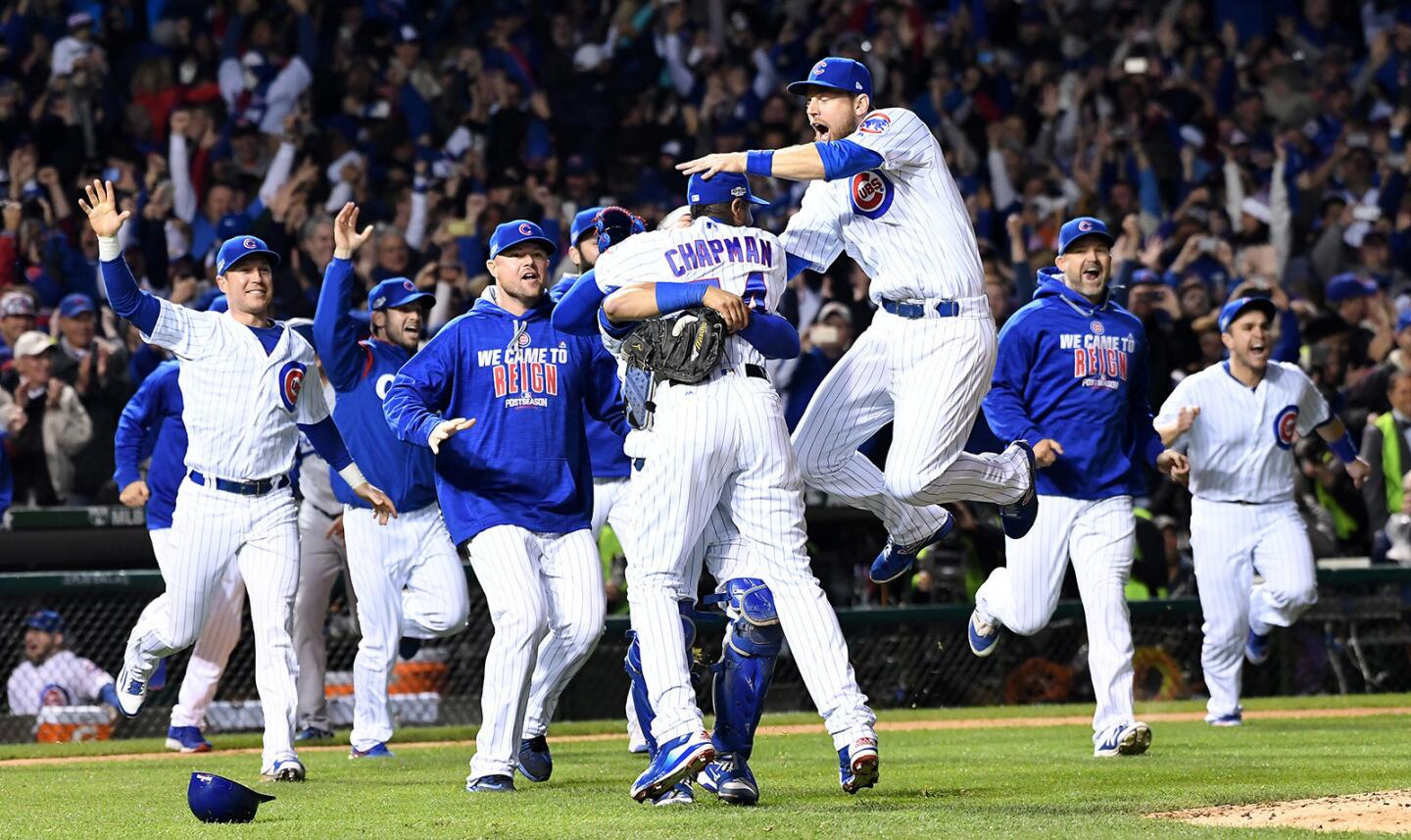Cubs players celebrate after defeating the Dodgers in Game 6 of the NLCS at Wrigley Field in Chicago.