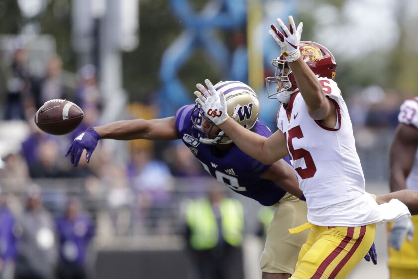 Washington's Kyler Gordon, left, knocks away a pass intended for Southern Cal's Drake London in the first half of an NCAA college football game Saturday, Sept. 28, 2019, in Seattle. (AP Photo/Elaine Thompson)