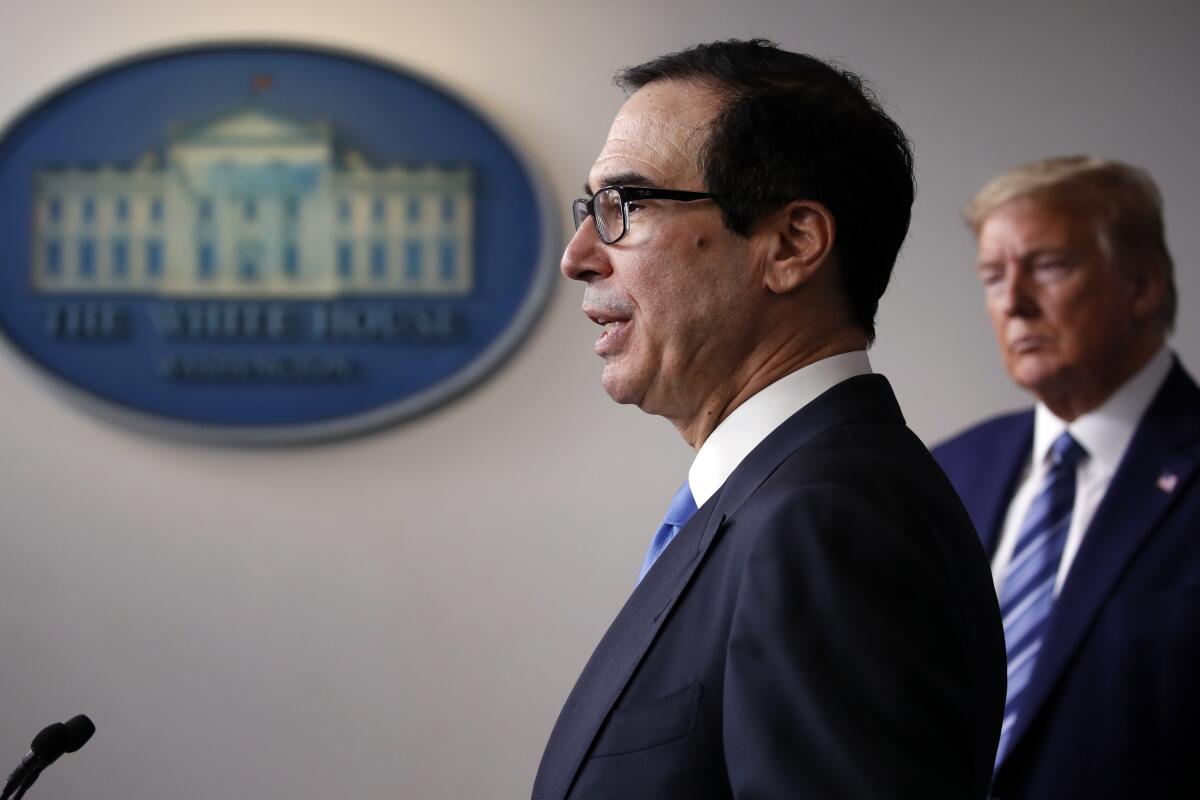 Treasury Secretary Steven T. Mnuchin, shown in April with President Trump, said last month that borrowers had criminal liability for taking loans they didn’t need. The Trump administration backpedaled Wednesday.